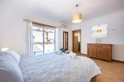 a bedroom with a large bed and a large window at CoolHouses Algarve Burgau, 3 Bed w/ plunge pool, close to village centre, Casa Boa Vida in Luz