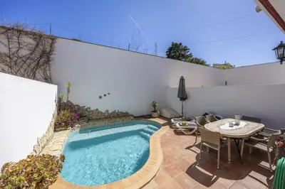 a living room with a couch and a television at CoolHouses Algarve Burgau, 3 Bed w/ plunge pool, close to village centre, Casa Boa Vida in Luz
