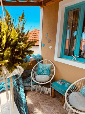 a patio with chairs and a table and a window at CASA BOHO your happy place in Calheta in Calheta
