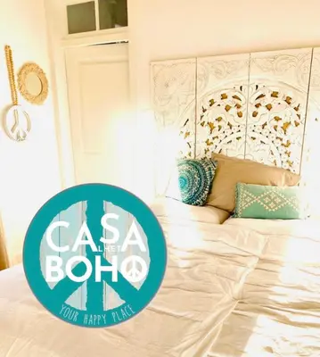 a bedroom with a bed with a blue and white sign at CASA BOHO your happy place in Calheta in Calheta