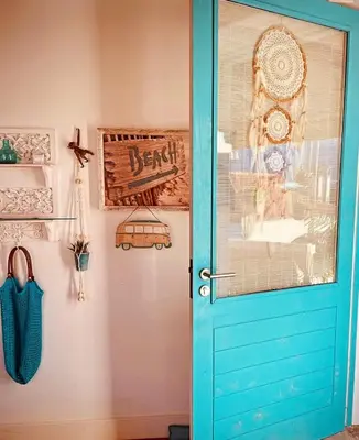 a blue door with a sign on a wall at CASA BOHO your happy place in Calheta in Calheta