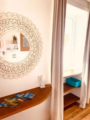a mirror hanging on a wall next to a window at CASA BOHO your happy place in Calheta in Calheta