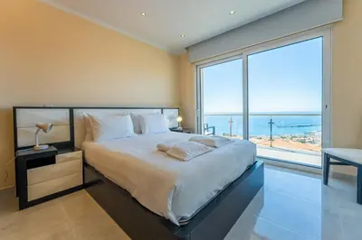 a bedroom with a large bed with a large window at FLH Funchal House with Sea View in Funchal