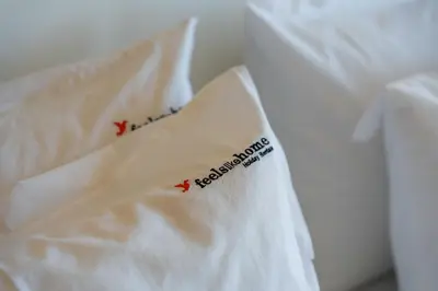 two white pillows with red writing on them at FLH Funchal House with Sea View in Funchal