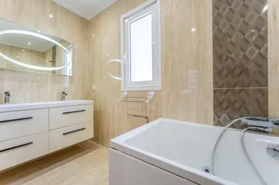 a bathroom with a white sink and a mirror at FLH Funchal House with Sea View in Funchal