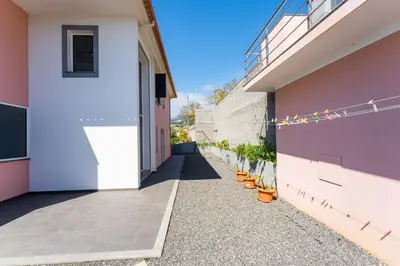 a walkway between two buildings with plants in pots at FLH Funchal House with Sea View in Funchal