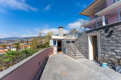 a stone house with a staircase leading up to a house at FLH Funchal House with Sea View in Funchal