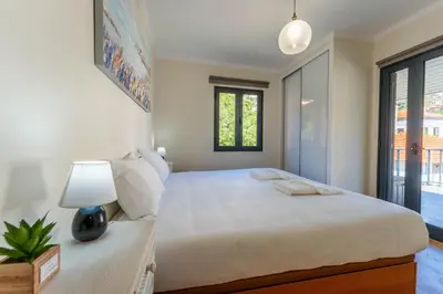 a bedroom with a large white bed with a lamp at FLH Santa Cruz Triplex with Terrace in Santa Cruz