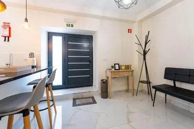 a kitchen with a black door and a table at FLH Santa Cruz Triplex with Terrace in Santa Cruz