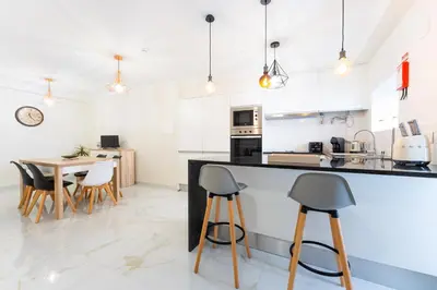 a kitchen and dining room with a table and chairs at FLH Santa Cruz Triplex with Terrace in Santa Cruz
