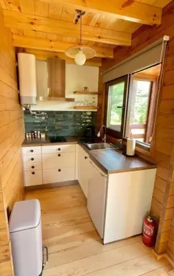 a kitchen with white cabinets and a sink in a cabin at Mountain Eco Shelter 8 in Funchal