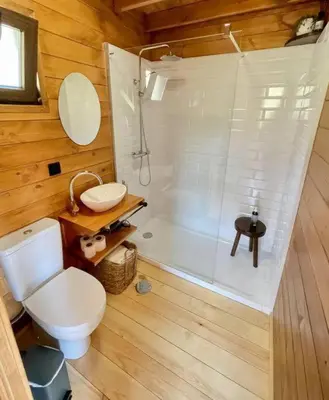 a bathroom with a white toilet and a shower at Mountain Eco Shelter 8 in Funchal