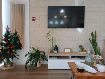 a living room with a christmas tree and a tv at Kings B&B Santa Cruz in Santa Cruz