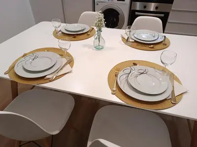 a white table with plates and glasses on it at Kings B&B Santa Cruz in Santa Cruz