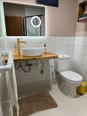 a bathroom with a sink and a toilet at Victoria Ocean View Room in Ponta do Pargo