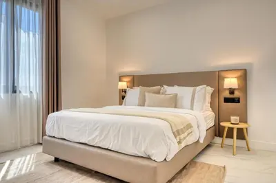 a bedroom with a large bed with white sheets and pillows at Beco Santa Emilia 2F, a Home in Madeira in Funchal
