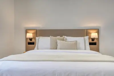 a bedroom with a large white bed with two lamps at Beco Santa Emilia 2F, a Home in Madeira in Funchal