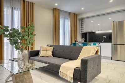 a living room with a couch and a kitchen at Beco Santa Emilia 2F, a Home in Madeira in Funchal