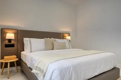 a bedroom with a large bed with white sheets and pillows at Beco Santa Emilia 2F, a Home in Madeira in Funchal