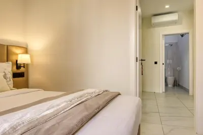 a bedroom with a bed and a bathroom at Beco Santa Emilia 3M, a Home in Madeira in Funchal