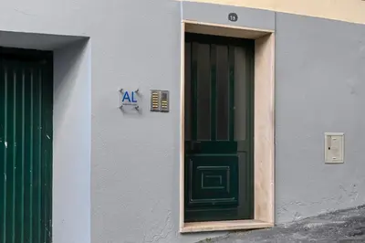 a building with a green door and a sign on it at Beco Santa Emilia 3M, a Home in Madeira in Funchal