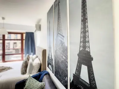 a bedroom with a picture of the eiffel tower at Ocean Breeze by LovelyStay in Funchal