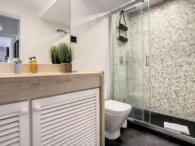 a bathroom with a toilet and a glass shower at Ocean Breeze by LovelyStay in Funchal