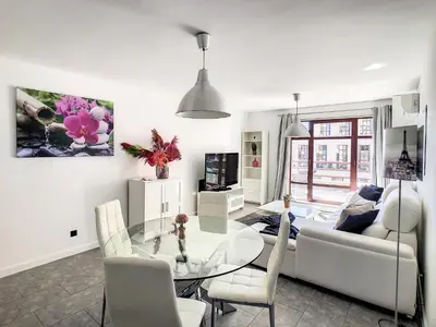 a living room with a glass table and a couch at Ocean Breeze by LovelyStay in Funchal