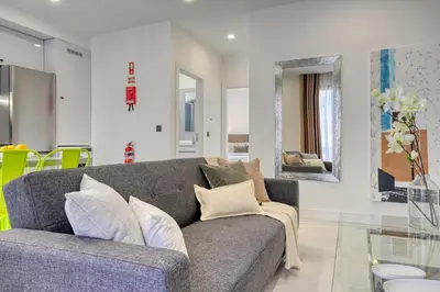 a living room with a gray couch and a glass table at Beco Santa Emilia 3J, a Home in Madeira in Funchal