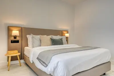 a bedroom with a large bed with white sheets and pillows at Beco Santa Emilia 3J, a Home in Madeira in Funchal