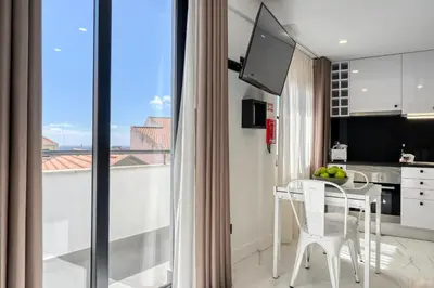 a kitchen and dining room with a table and a window at Beco Santa Emilia 4Q, a Home in Madeira in Funchal