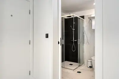 a shower with a glass door in a bathroom at Beco Santa Emilia 4Q, a Home in Madeira in Funchal