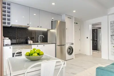 a kitchen with a bowl of fruit on a table at Beco Santa Emilia 4Q, a Home in Madeira in Funchal
