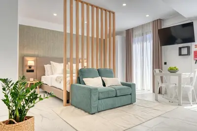 a bedroom with a bed and a blue chair in front of a bedroom at Beco Santa Emilia 4Q, a Home in Madeira in Funchal