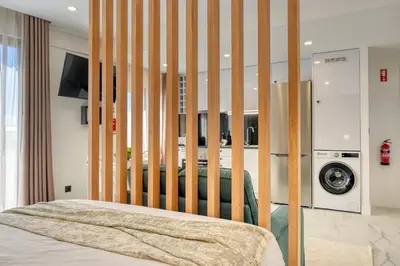 a bedroom with a bed with a wooden headboard at Beco Santa Emilia 4Q, a Home in Madeira in Funchal