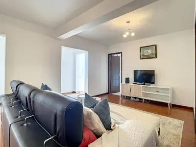 a living room with a leather couch and a tv at Villa Formosa View by Atlantic Holiday in Funchal