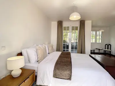 a bedroom with a large white bed with white pillows at Villa Formosa View by Atlantic Holiday in Funchal