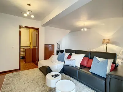 a living room with a black couch with colorful pillows at Villa Formosa View by Atlantic Holiday in Funchal