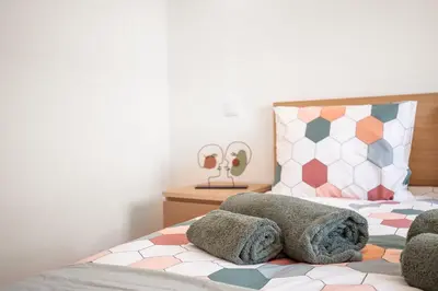 a bedroom with a bed with a stuffed animal on it at Casa 7 Gerações in Sagres