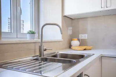 a stainless steel sink in a kitchen with a window at Casa 7 Gerações in Sagres
