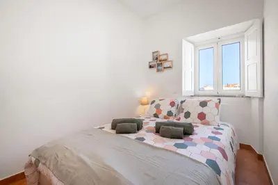 a bedroom with a bed with two pillows on it at Casa 7 Gerações in Sagres