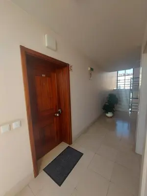 a hallway with a wooden door and a potted plant at Horizon Dream in Funchal