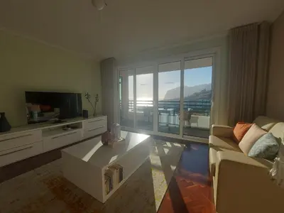 a living room with a couch and a tv at Horizon Dream in Funchal