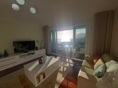 a living room with a couch and a tv at Horizon Dream in Funchal