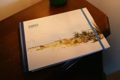 a book sitting on top of a table at Panorama Apartment Sagres *Pool* in Sagres