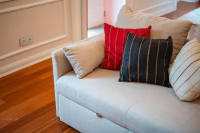 a white couch with three pillows on it at Madeira Loft II - FREE CAR in Caniço