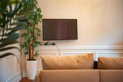 a living room with a couch and a flat screen tv at Madeira Loft II - FREE CAR in Caniço