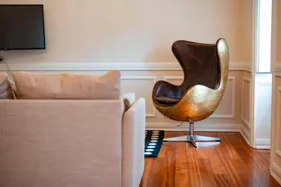 a chair sitting in a living room next to a couch at Madeira Loft II - FREE CAR in Caniço