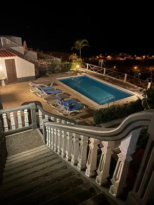 a swimming pool on a balcony at night at Tropical Garden in Arco da Calheta