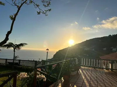 a view of the sun setting over the ocean at Tropical Garden in Arco da Calheta